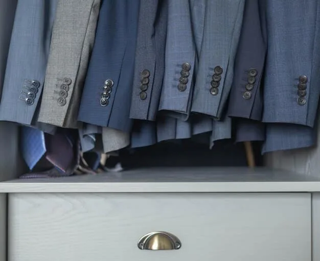 A neatly organized closet with versatile pieces like blazers, comfortable tops, and stylish trousers, all within a neutral color palette.