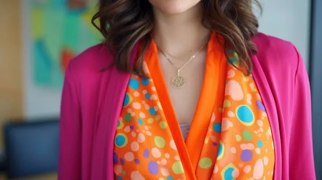 A close-up shot of a stylish work-from-home outfit featuring a simple top, delicate necklace, and a brightly colored scarf.