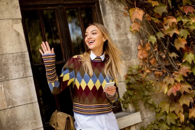 A fashion blogger showcasing a fall outfit consisting of a plaid blazer, a cable-knit sweater, and dark wash jeans. She is standing in front of a brick wall, and the overall aesthetic is cozy and autumnal.