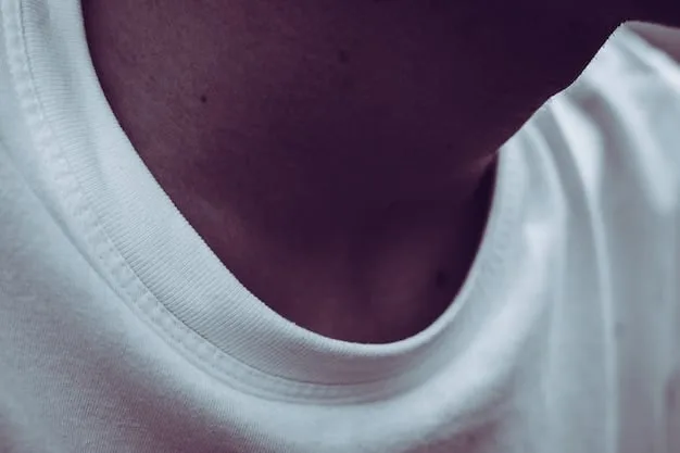 A close-up shot of various white t-shirts showing different fabric textures and neckline styles - crew neck, v-neck, and scoop neck.