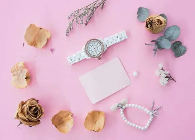 A flat lay showcasing budget-friendly accessories inspired by Ariana Grande, including a set of delicate gold necklaces, a pair of simple hoop earrings, various colorful scrunchies, and a selection of hair clips, all arranged on a pink background.