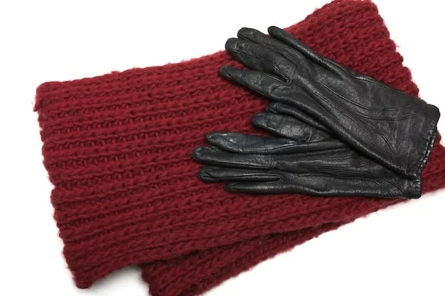 A flat lay of various winter accessories, including a chunky knit scarf, leather gloves, a wool beanie, and a pair of insulated boots. The image should showcase the textures and colors of each item, emphasizing their functionality and style.