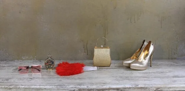 An organized display of affordable red carpet accessories, including high heels, statement jewelry, clutches, and belts, all priced under $50 each. The accessories are arranged to showcase their elegance and versatility.