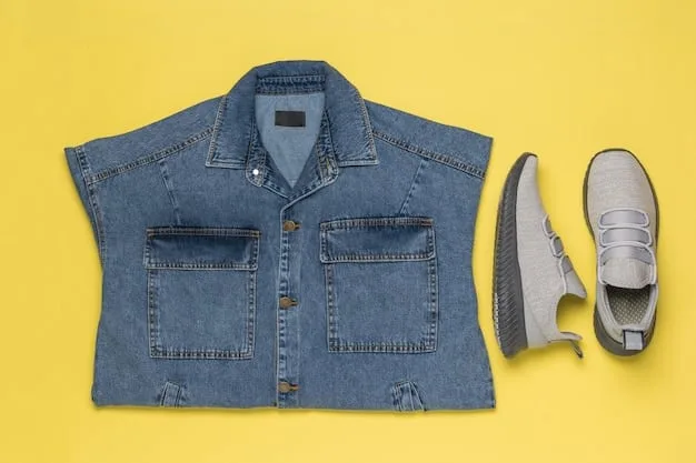 A detailed flat lay of a classic denim jacket, a simple white tank top folded neatly, light wash straight-leg jeans, and a pair of minimalist brown leather ankle boots, demonstrating a cohesive outfit.