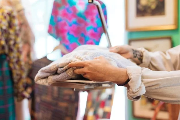 A close-up shot of hands meticulously sifting through a clothing rack in a well-organized thrift store, highlighting the process of finding hidden gems for a budget capsule wardrobe.