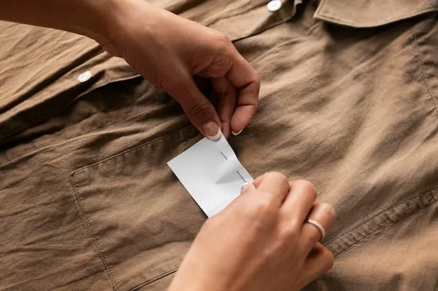 Close-up shot of a person's hands carefully inspecting the label of a designer garment in a thrift store. Focus on the label details and the act of authentication.