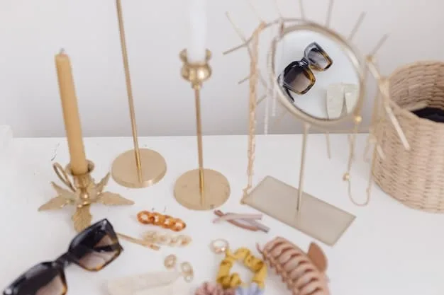 A close-up shot of various affordable accessories neatly arranged on a mirrored tray. Items include delicate gold necklaces, colorful beaded bracelets, simple stud earrings, and a patterned silk scarf. The background is soft and blurred.