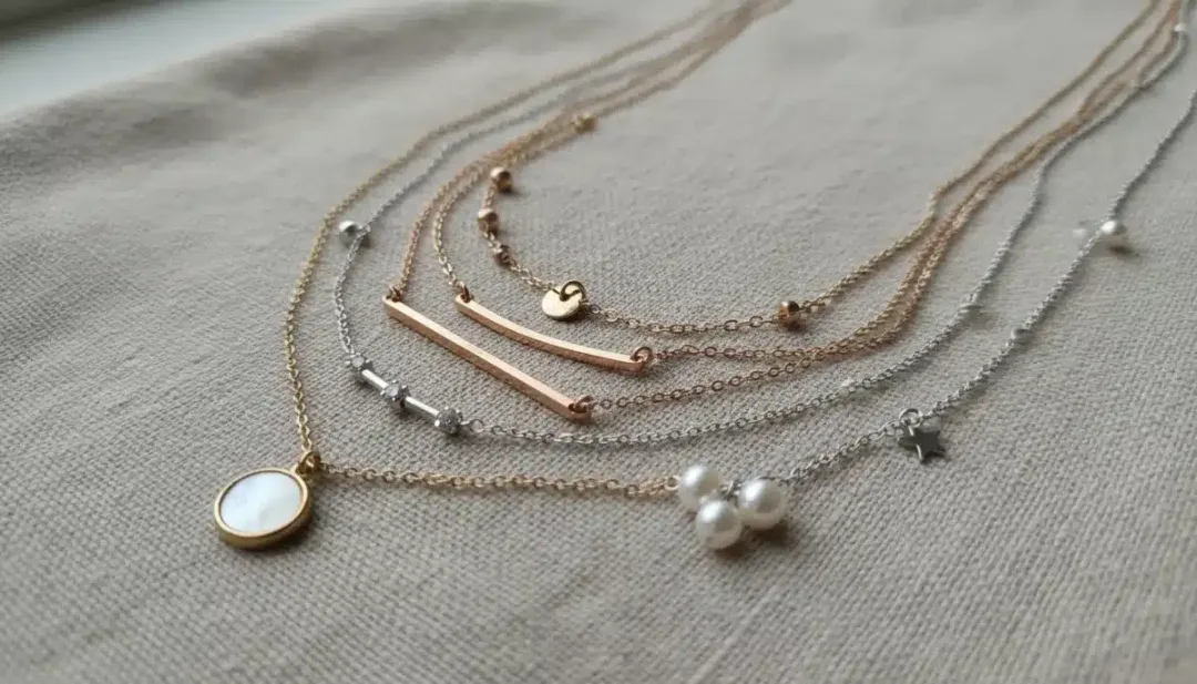 Close-up of layered delicate necklaces, demonstrating affordable accessorizing