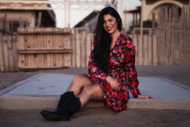 Olivia Rodrigo wearing a pair of black chunky platform boots with a floral dress. She is standing on a city sidewalk, and the background is blurred to emphasize her outfit. The boots are a focal point of the image, showcasing their bold and edgy style.
