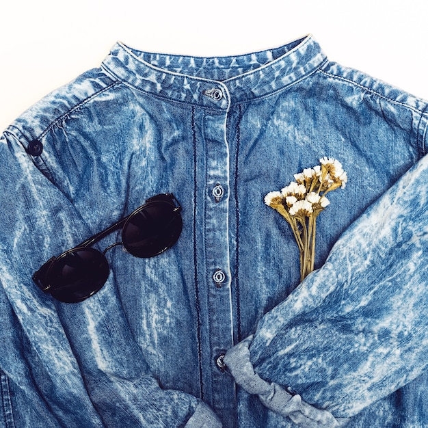 A collage featuring close-up shots of various clothing textures and accessories: a denim jacket, a silk scarf, chunky sneakers, a leather belt, and a pair of sunglasses. The images highlight the importance of focusing on textures and details when replicating a celebrity outfit on a budget.