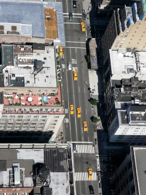 An aerial view of a bustling city street in a major US city (e.g., New York or Los Angeles), with pedestrians wearing a variety of luxury outerwear styles. This highlights the real-world application and visibility of these fashion trends.