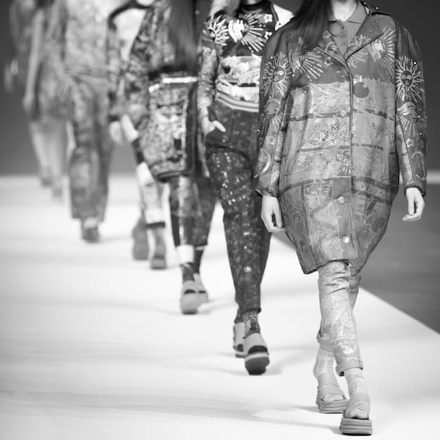 A runway scene from the Independent Designer's Runway Show (IDRS), showcasing a diverse range of styles and designs from independent designers. Focus on the energy and excitement of the show, with models walking confidently and the audience captivated.