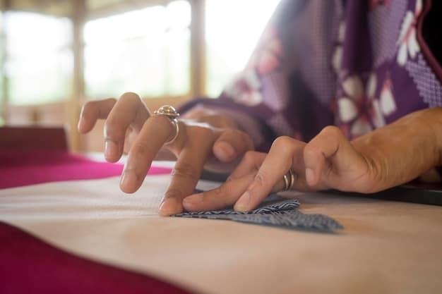 A close-up shot of a textile designer's hands working on a unique fabric pattern using traditional techniques.