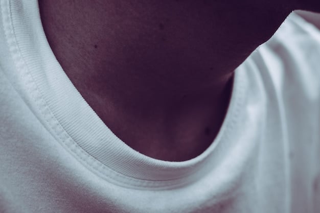 A close-up shot of various white t-shirts showing different fabric textures and neckline styles - crew neck, v-neck, and scoop neck.