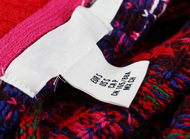 A close-up shot of garment labels showing fabric composition details. Focus on labels indicating high percentages of natural fibers like 