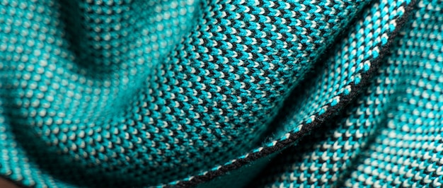 A detailed shot showcasing various fabric weaves (twill, satin, plain weave) and knit structures (jersey, rib knit, cable knit). Highlight the differences in texture and density and explain how these variations affect fabric durability and drape.