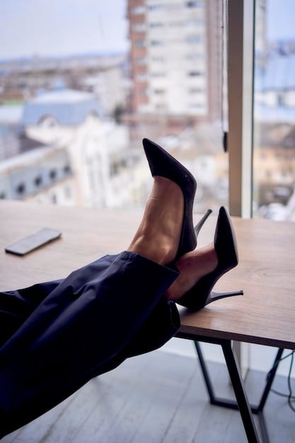 A close-up shot of a woman's feet wearing a pair of stylish and affordable black pumps, paired with a professional-looking skirt suit. The background should be a modern office setting.