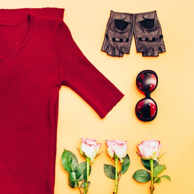 A flat lay arrangement featuring a well-curated selection of spring wardrobe items, including a dress in the Pantone Color of the Year 2025, a neutral-toned trench coat, a patterned scarf with floral accents, and a pair of stylish sunglasses. The items are thoughtfully placed on a light-colored surface, creating an inviting and chic spring aesthetic.