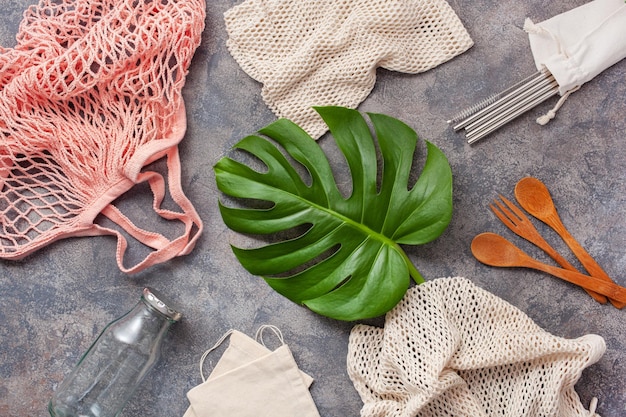 A close-up shot showcasing several different eco-friendly fabrics, including organic cotton, bamboo fabric, recycled polyester made from plastic bottles, and a sample of pineapple leather (Piñatex). The image highlights the textures and unique qualities of each material against a neutral background.